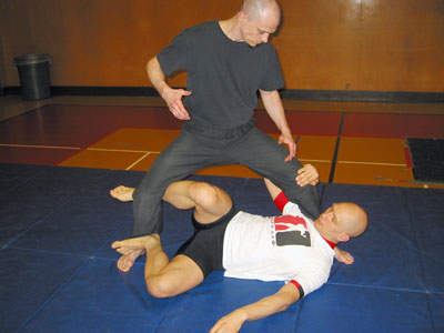 The Scissor X Guard position