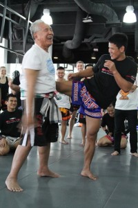 3. Muay Thai Grandmaster Kru Yodtong Senanan demonstrating techniques with Yoddecha Sityodtong