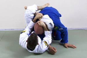 Brandon finishes the triangle choke by pulling down on my head and on his own shin, squeezing in with his legs, and doing a slight crunch upwards