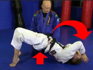 The fundamental movement of this escape: bridging your hips upward, and then framing with your elbows to hold your opponent above your head