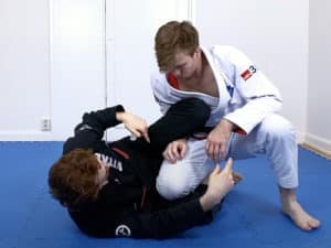 To strip his grip establish your knee shield over his forearm and then push your knee away