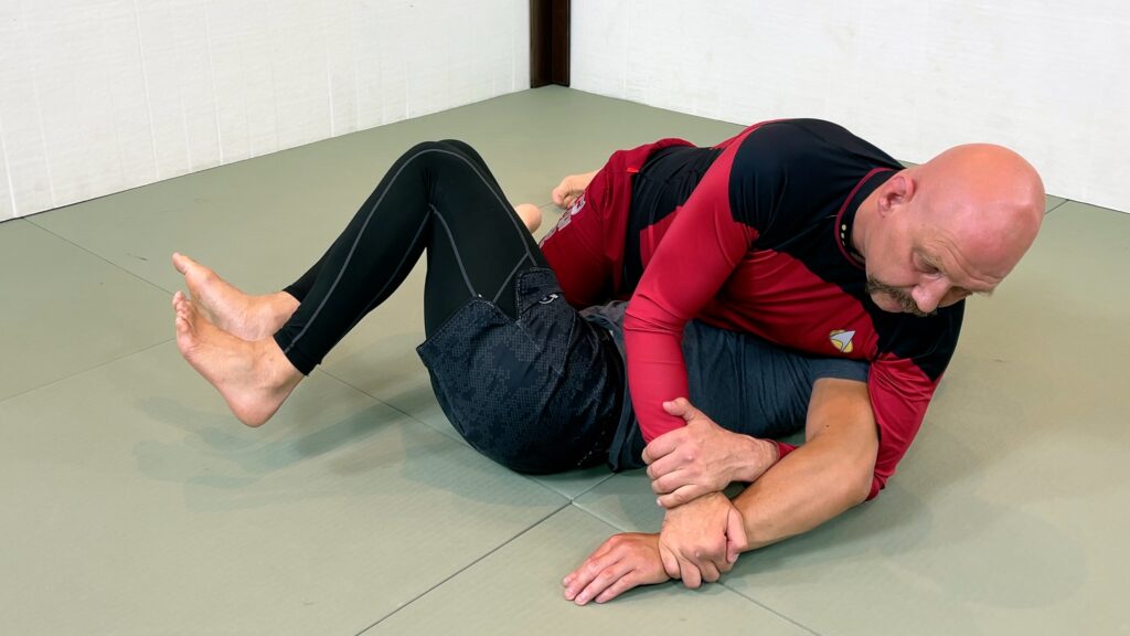 You're now in side control with the Kimura grip.
